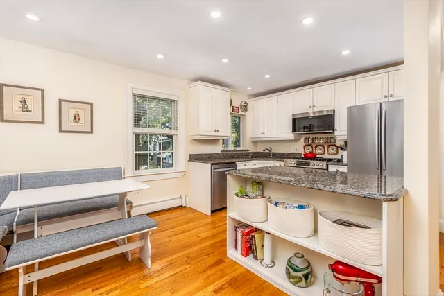 a kitchen with stainless steel appliances granite countertop a refrigerator and a stove top oven