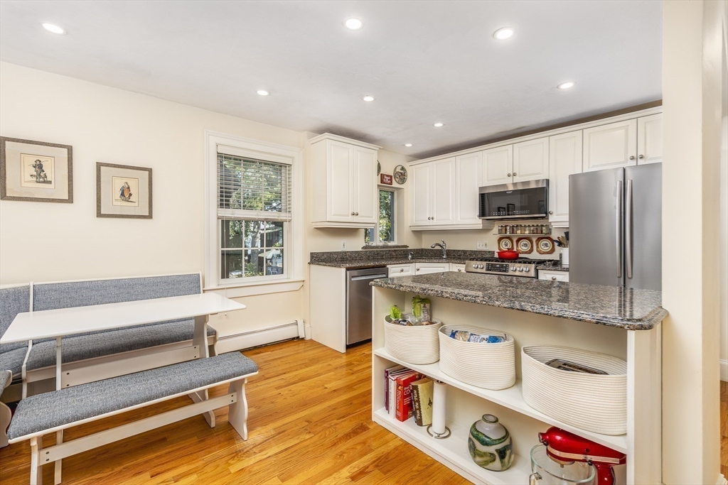 10 Andrew Street, Unit 2A Salem, MA 01970 - Photo 9 of 27 a kitchen with stainless steel appliances granite countertop a refrigerator and a stove top oven