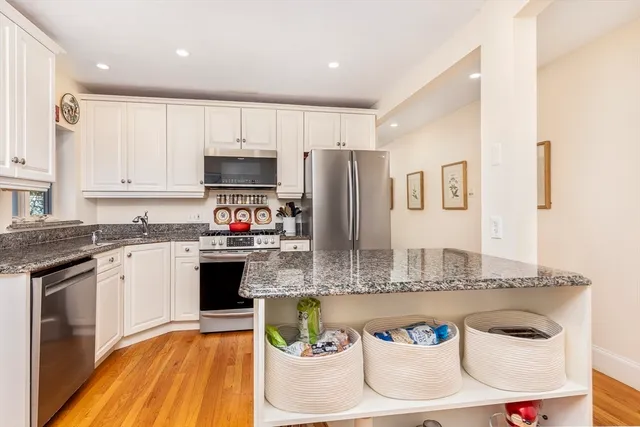 a large kitchen with stainless steel appliances granite countertop a granite counter tops and a sink