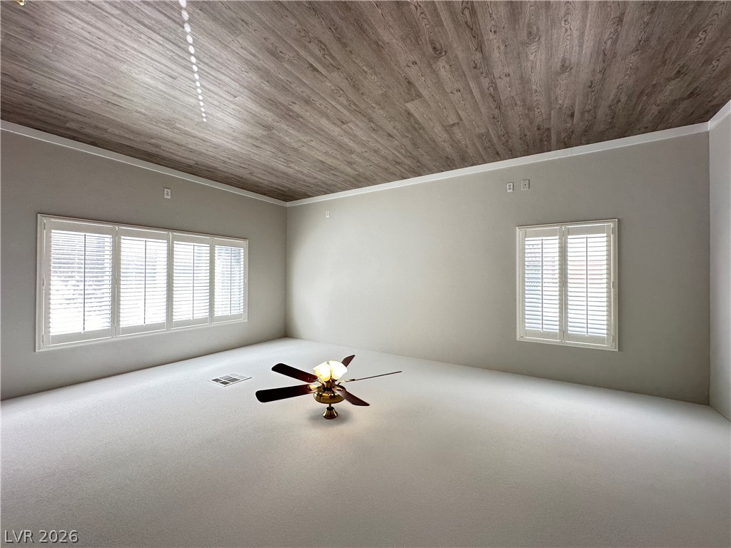 10191 Splendor Ridge Avenue Las Vegas, NV 89135 - Photo 25 of 31 A spacious room features plush carpeting, crown molding, and bright windows with elegant plantation shutters.