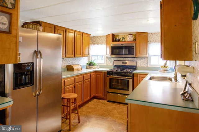 a kitchen with a stove a sink and a microwave