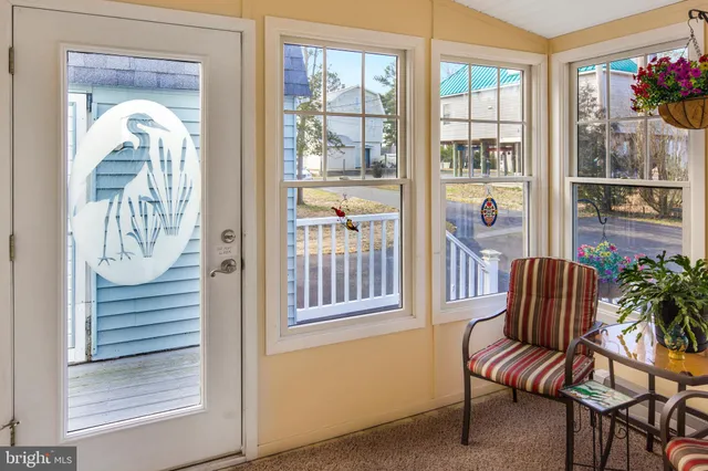 a balcony with furniture and a potted plant