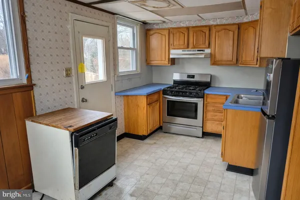 a kitchen with a stove and a sink