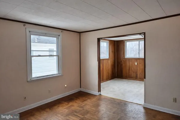 an empty room with windows and closet