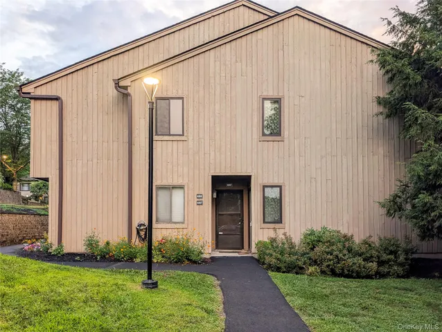 a blue house with garden in front of it
