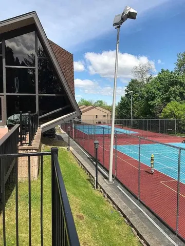 a view of a balcony with floor to ceiling windows