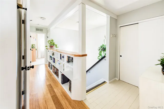 a view of a hallway to a room with stair