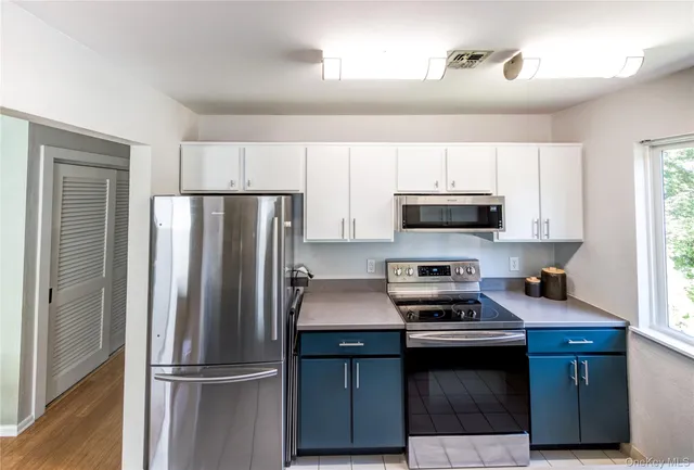 a kitchen with a refrigerator stove and microwave