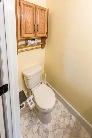 a white toilet sitting next to a window