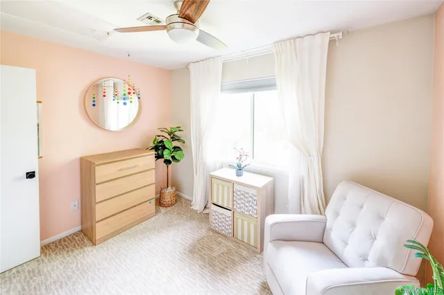 a living room with furniture a bed and a window