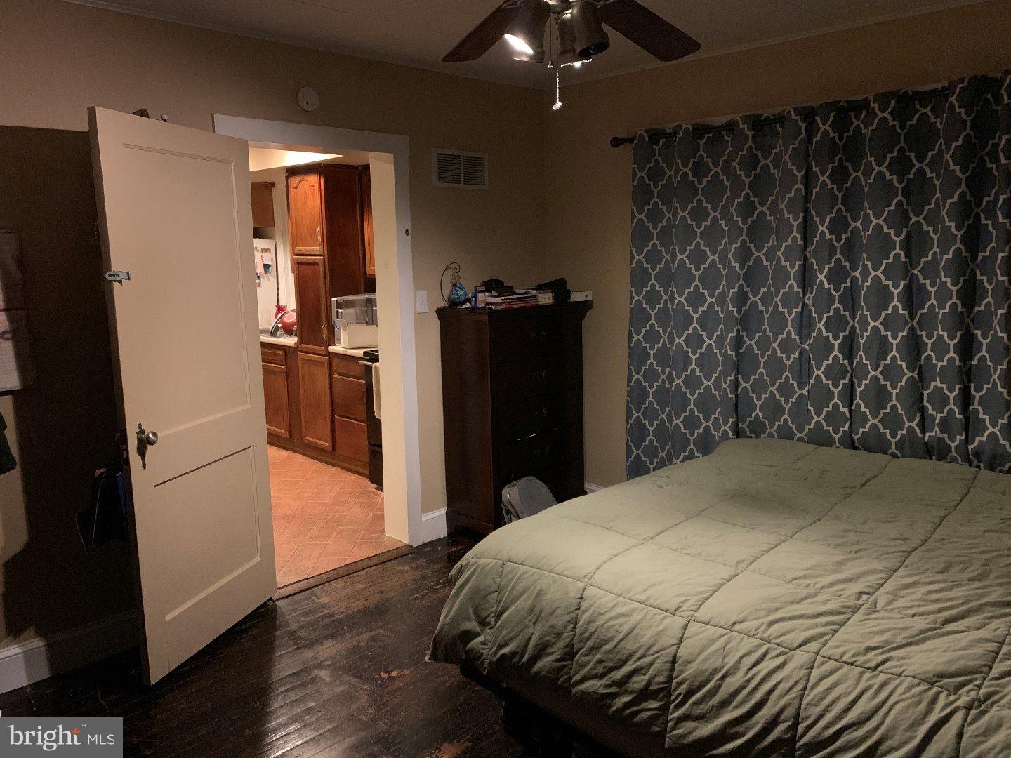 555 Chestnut Street, Unit REAR West Reading, PA 19611 - Photo 4 of 11 a bedroom with a bed and wooden floor