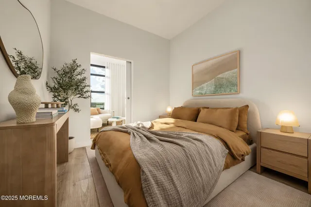 a bedroom with a bed and a potted plant