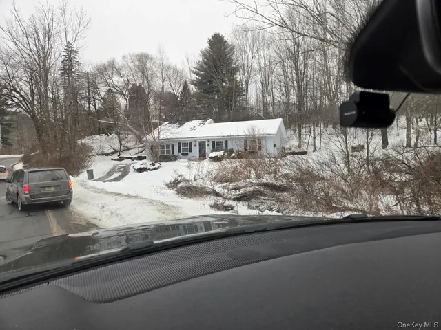 a view of a yard and front view of a house