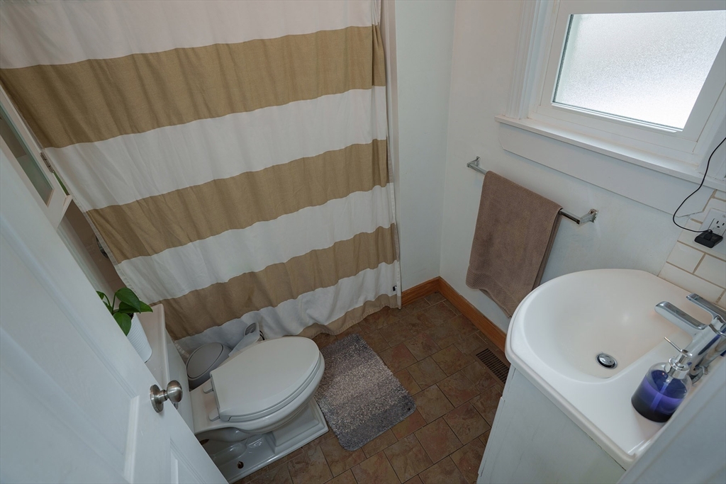 80 Collins Street Lynn, MA 01902 - Photo 12 of 25 a bathroom with a sink toilet and shower