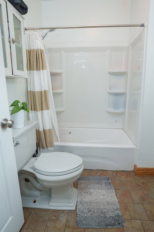 80 Collins Street Lynn, MA 01902 - Photo 13 of 25 a bathroom with a toilet and a bathtub