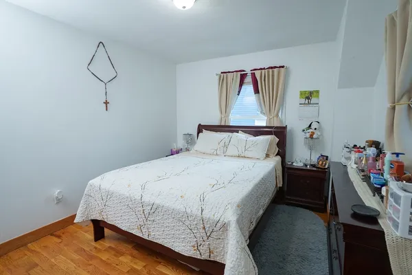 a bedroom with a bed and window