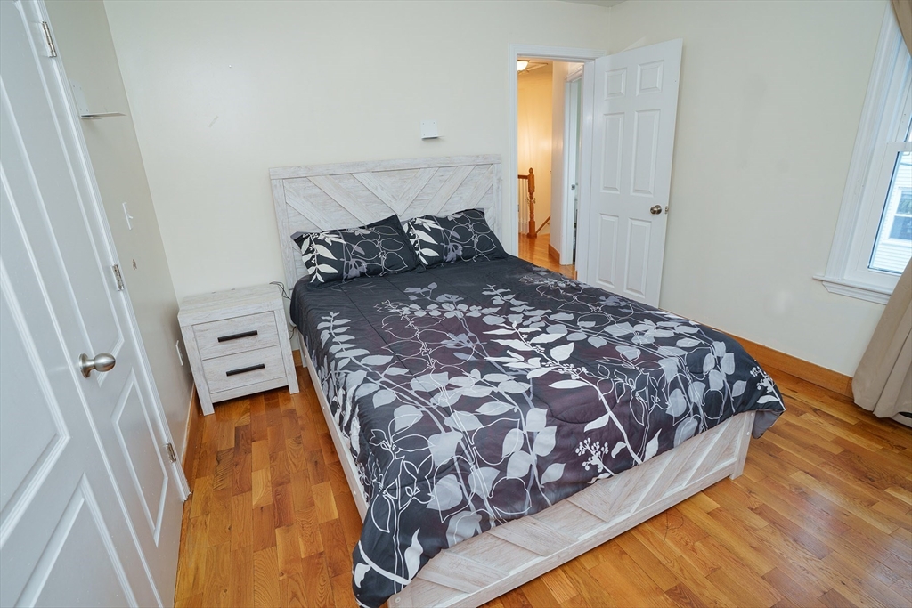 80 Collins Street Lynn, MA 01902 - Photo 17 of 25 a bed sitting in a bedroom next to a window