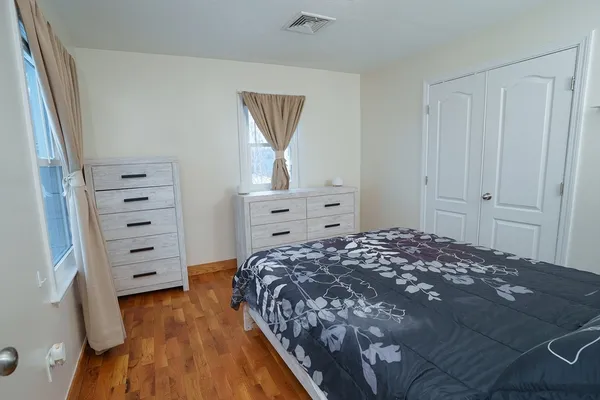 a bedroom with a bed and a dresser
