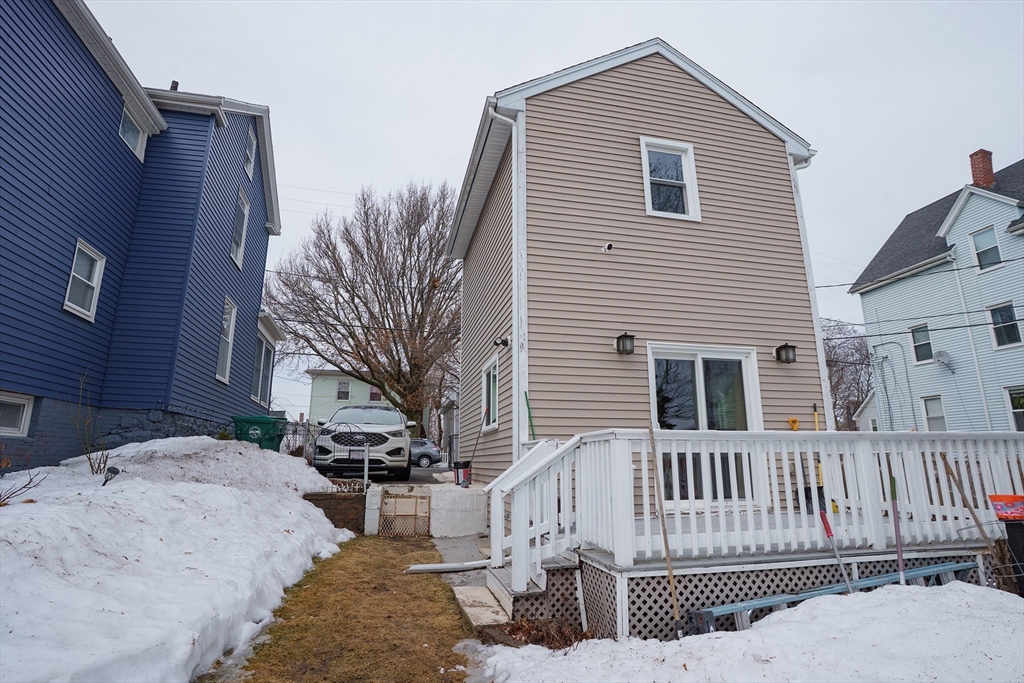 80 Collins Street Lynn, MA 01902 - Photo 23 of 25 a view of a house with wooden fence