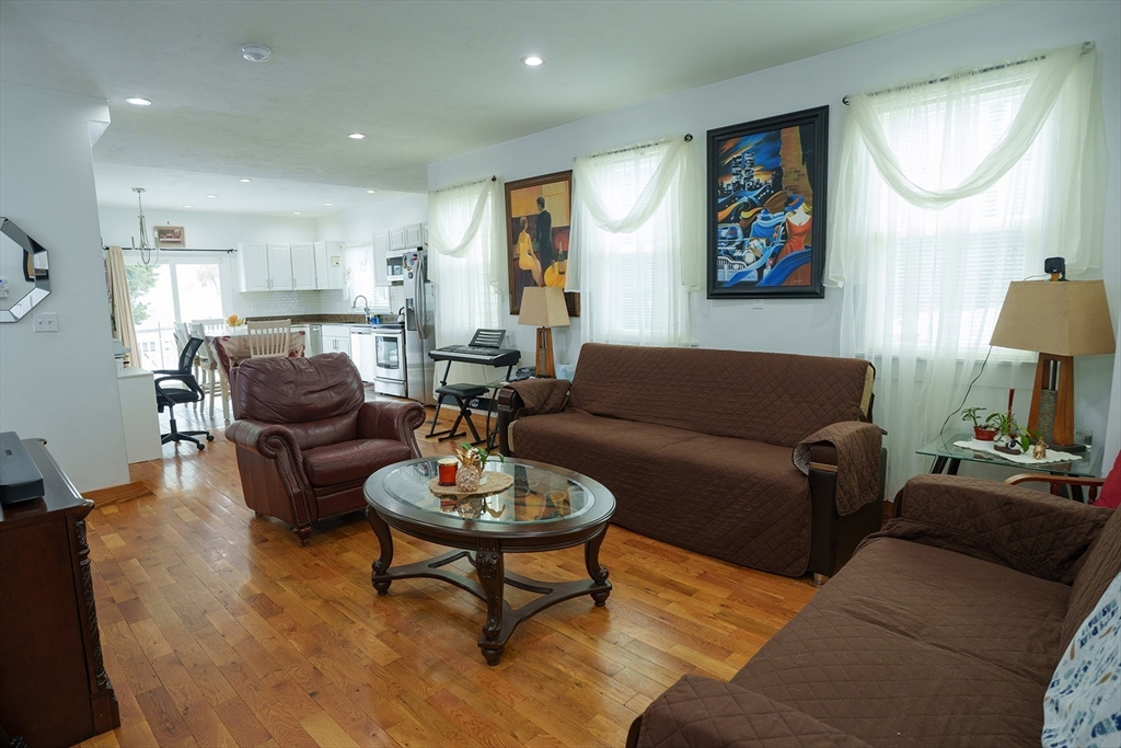 80 Collins Street Lynn, MA 01902 - Photo 5 of 25 a living room with furniture a rug kitchen view and a window