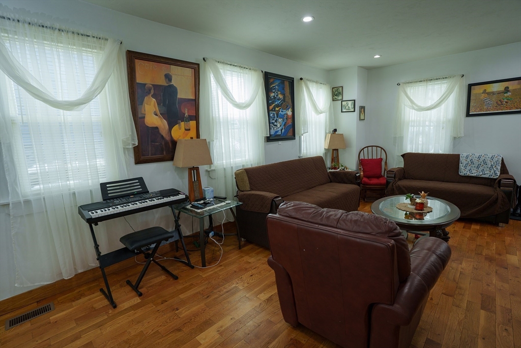 80 Collins Street Lynn, MA 01902 - Photo 6 of 25 a living room with furniture and a wooden floor