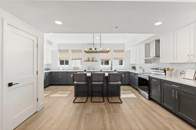 a large kitchen with a table and chairs