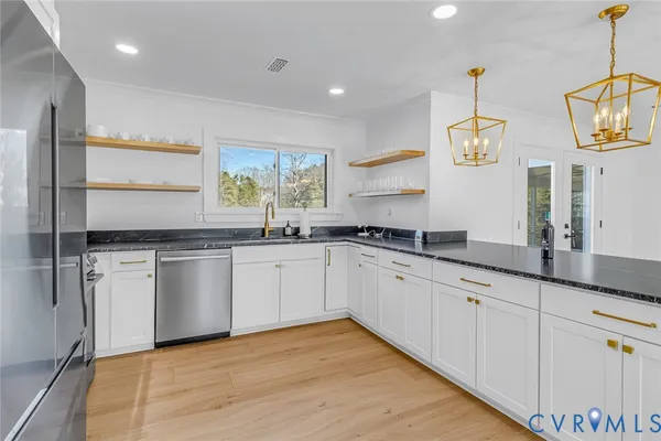 a spacious bathroom with double sink and a wooden floor