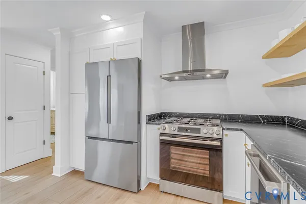a bathroom with a granite countertop sink a toilet and shower