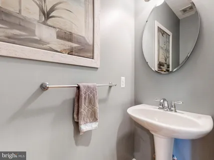 a view of a hallway with wooden floor and stairs