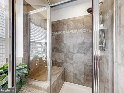 a view of an empty room and chandelier fan