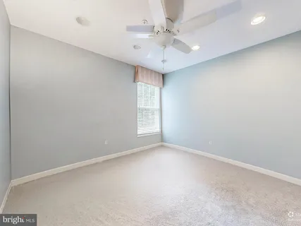 a view of a hallway with closet and wooden floor
