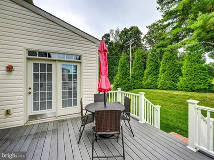a living room with furniture and a dining table with wooden floor
