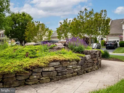 a view of an house with backyard space and garden