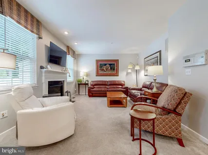 a living room with furniture fireplace and a flat screen tv