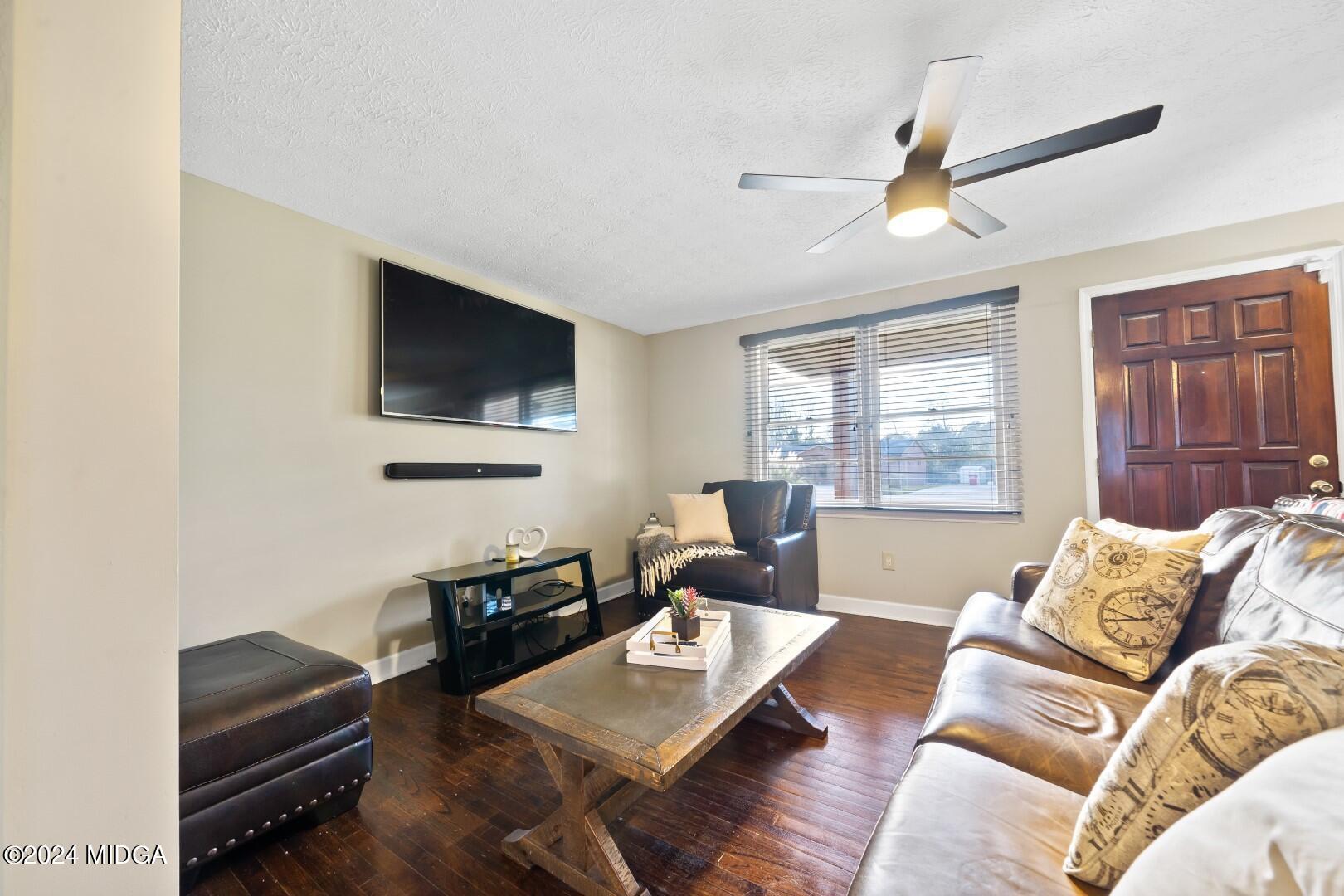 4742 Brookhaven Road Macon, GA 31206 - Photo 8 of 34 a living room with furniture and a flat screen tv