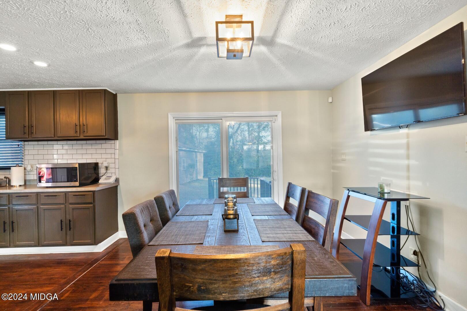 4742 Brookhaven Road Macon, GA 31206 - Photo 9 of 34 a view of a dining room with furniture a rug and wooden floor