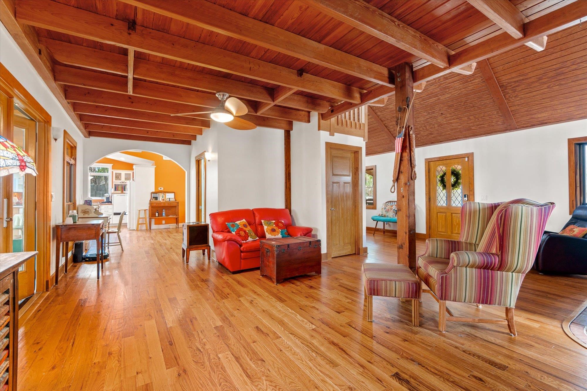 68 Kings Ferry Way St. Augustine, FL 32084 - Photo 12 of 52 Living area featuring wooden ceiling, arched walkways, wood finished floors, and vaulted ceiling with beams
