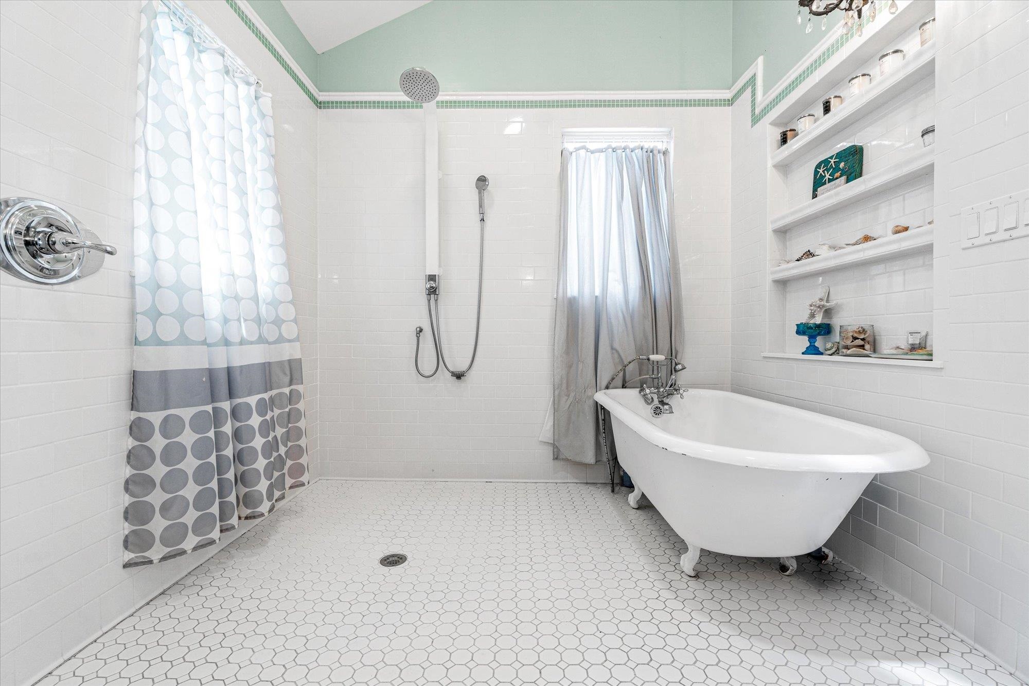 68 Kings Ferry Way St. Augustine, FL 32084 - Photo 22 of 52 Full bath with a freestanding tub, tiled shower, tile walls, lofted ceiling, and light tile patterned floors