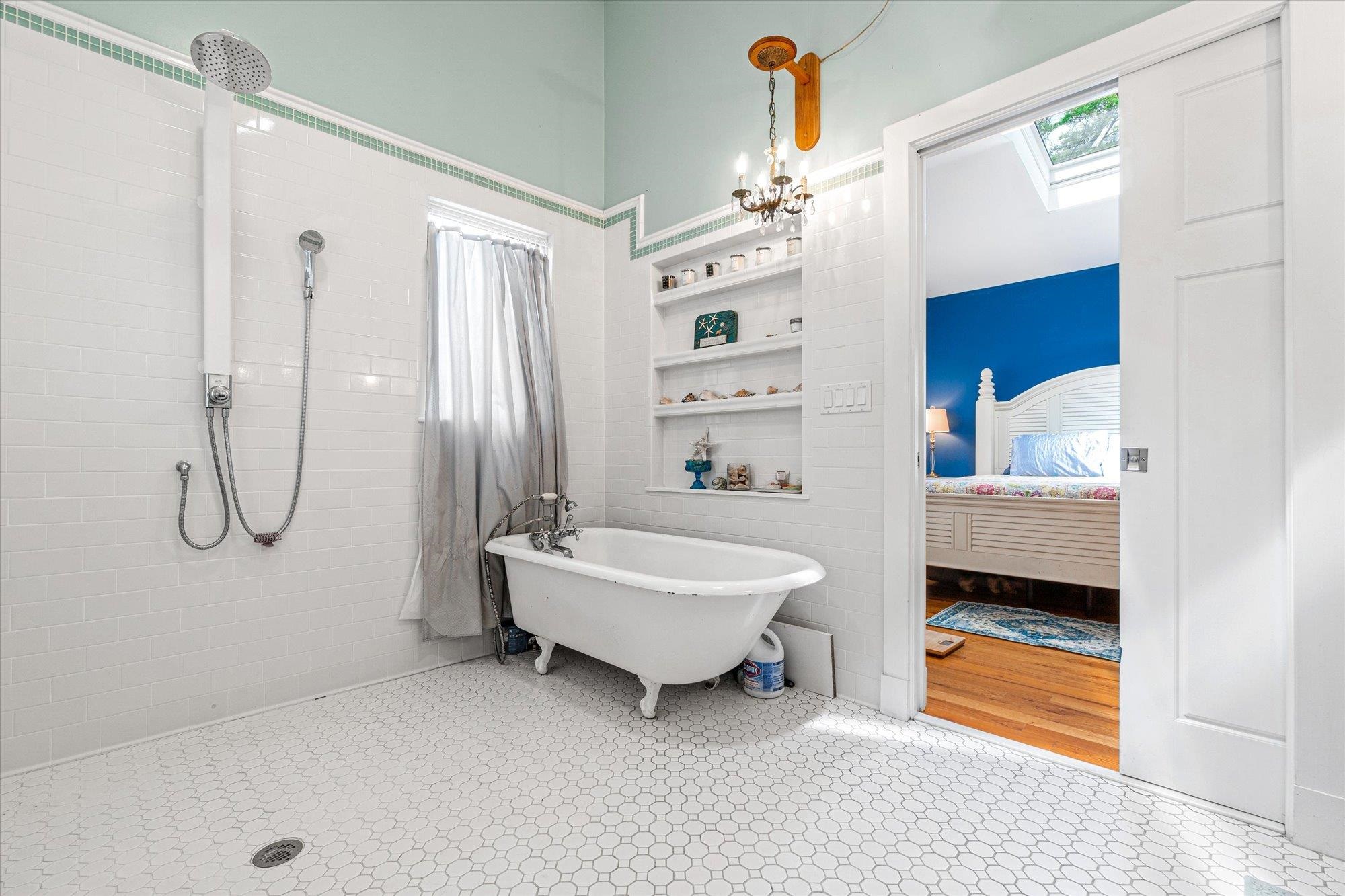 68 Kings Ferry Way St. Augustine, FL 32084 - Photo 23 of 52 Ensuite bathroom with a skylight, a freestanding tub, a tile shower, built in shelves, and light flooring