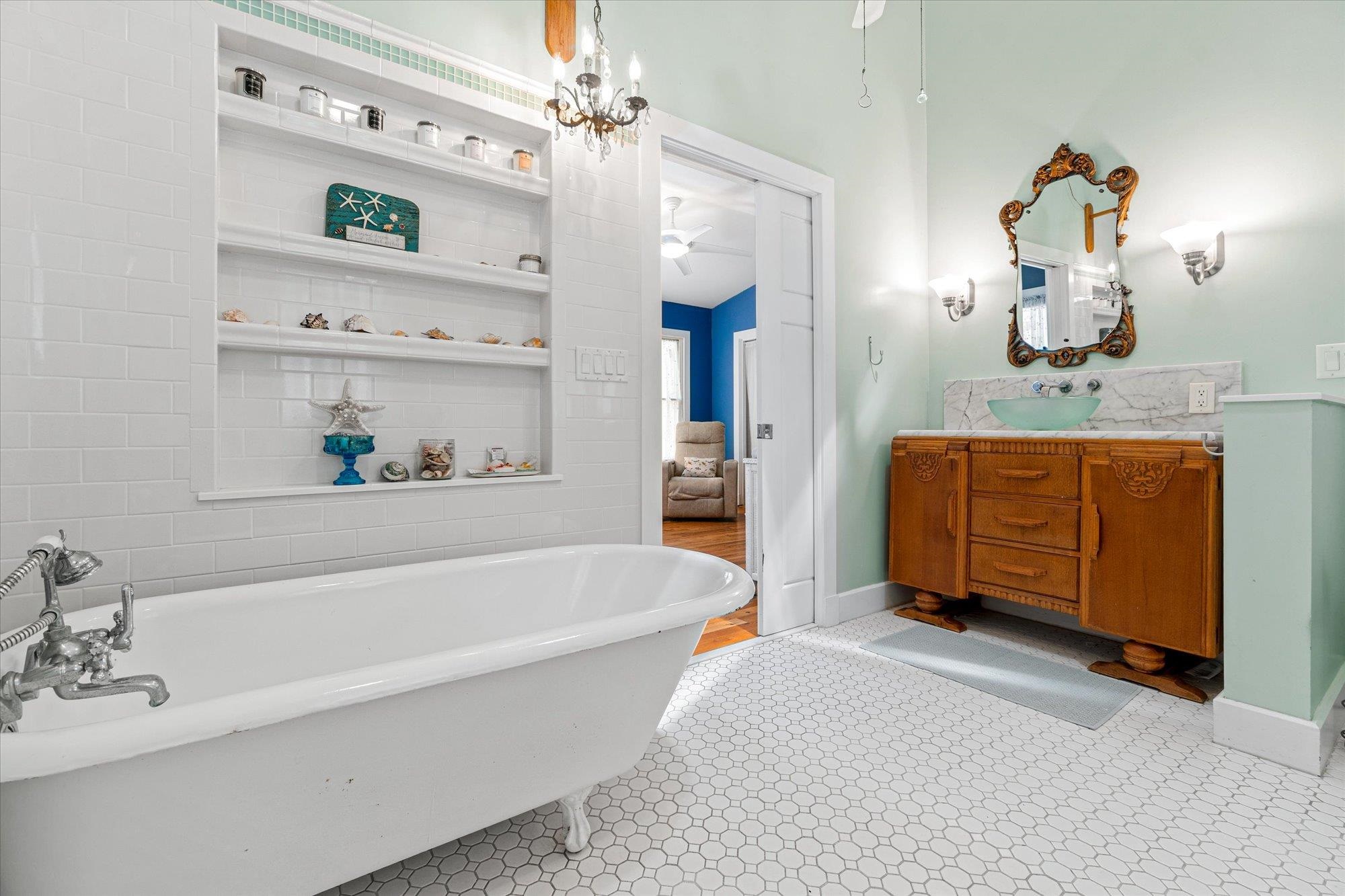 68 Kings Ferry Way St. Augustine, FL 32084 - Photo 24 of 52 Bathroom with vanity, a freestanding bath, ceiling fan, and built in shelves