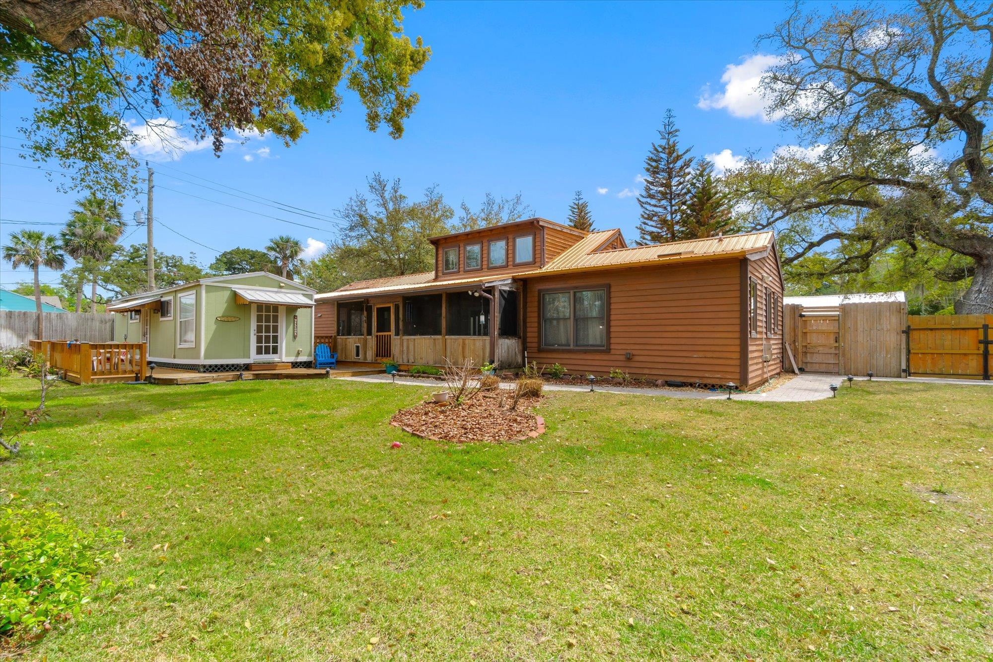 68 Kings Ferry Way St. Augustine, FL 32084 - Photo 34 of 52 Rear view of house with a metal roof, a gate, and a wooden deck