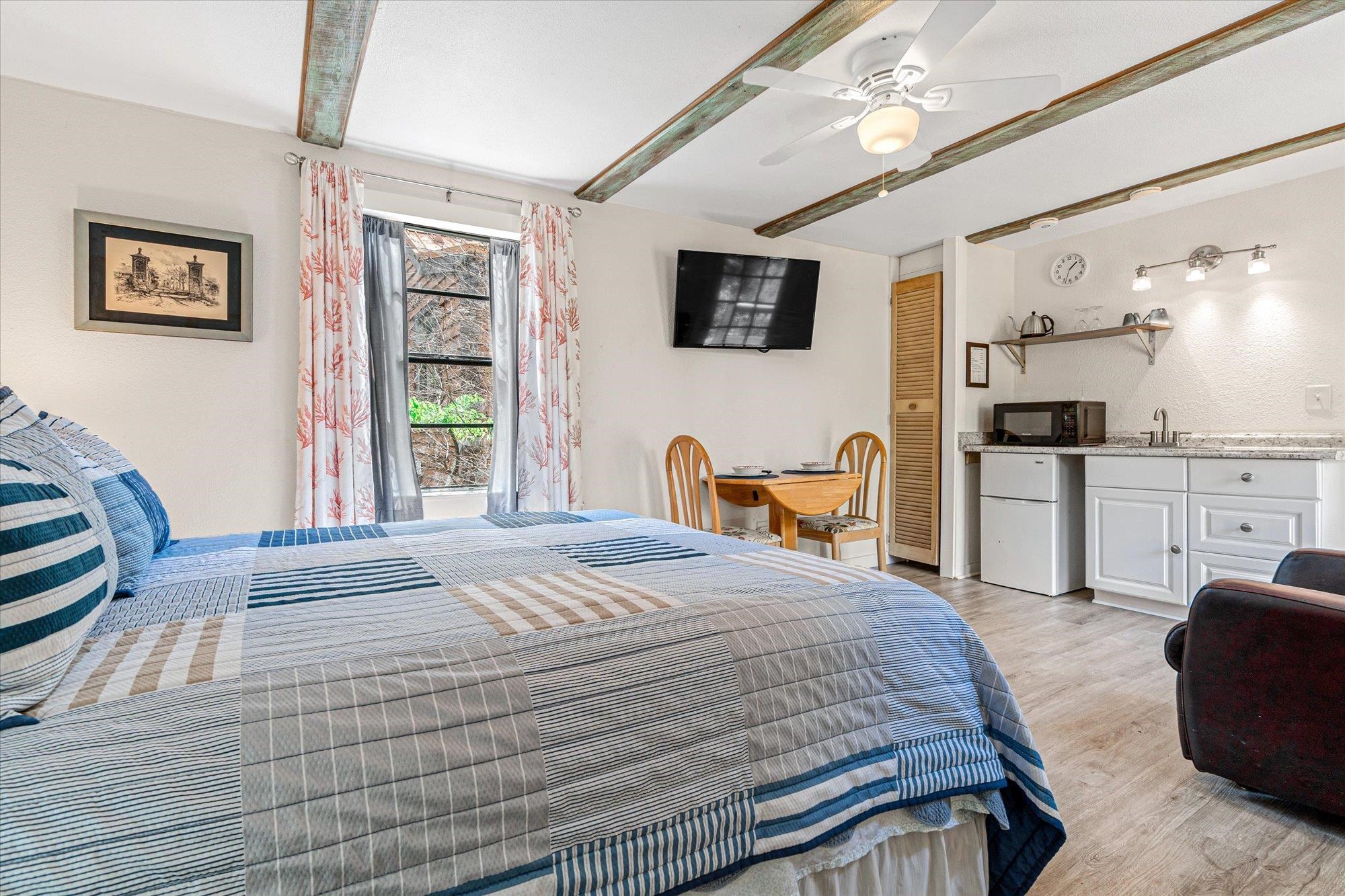 68 Kings Ferry Way St. Augustine, FL 32084 - Photo 40 of 52 Bedroom featuring light wood finished floors, beam ceiling, freestanding refrigerator, and ceiling fan
