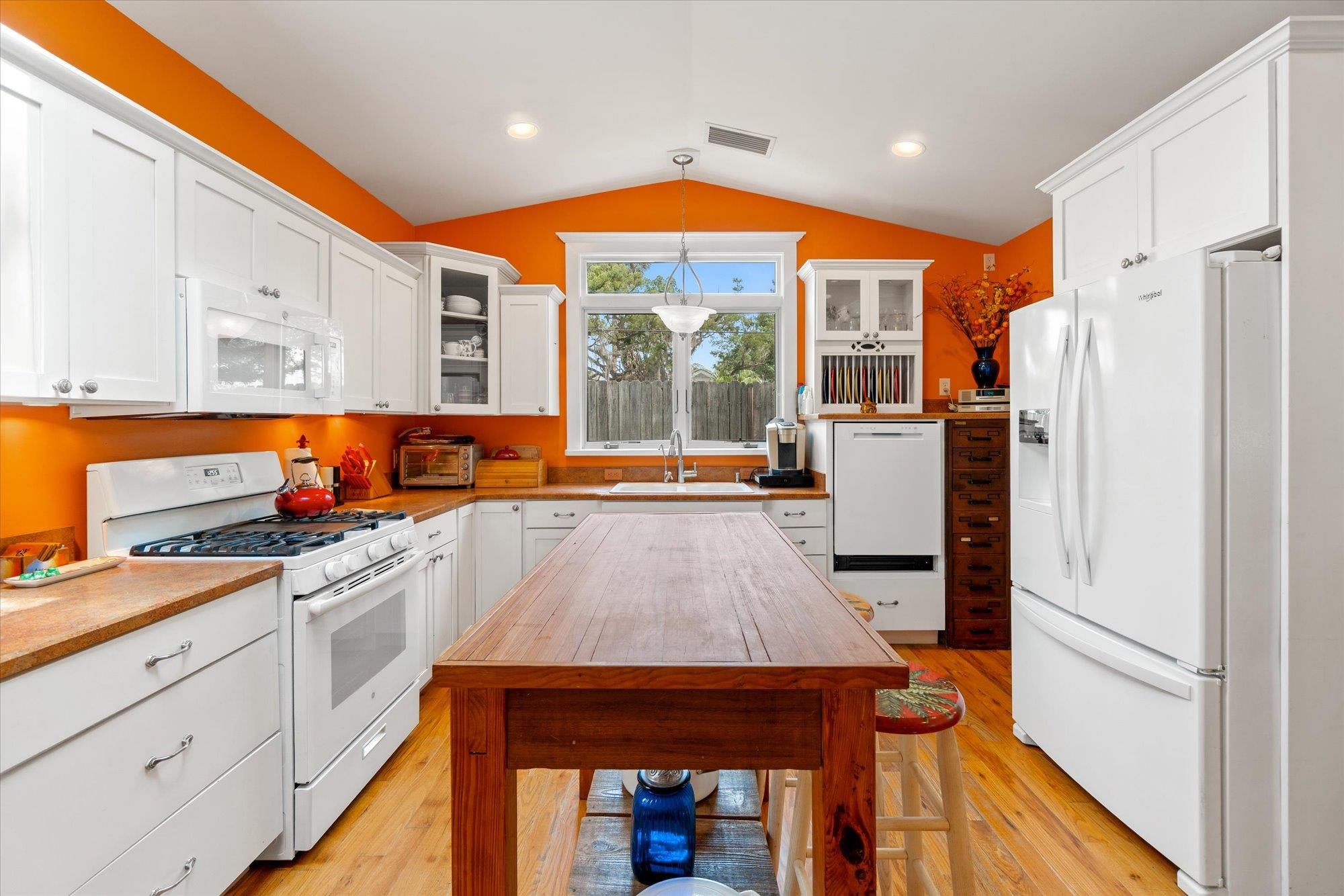 68 Kings Ferry Way St. Augustine, FL 32084 - Photo 8 of 52 Kitchen featuring white appliances, accented glass front cabinets, white cabinets, and pendant lighting
