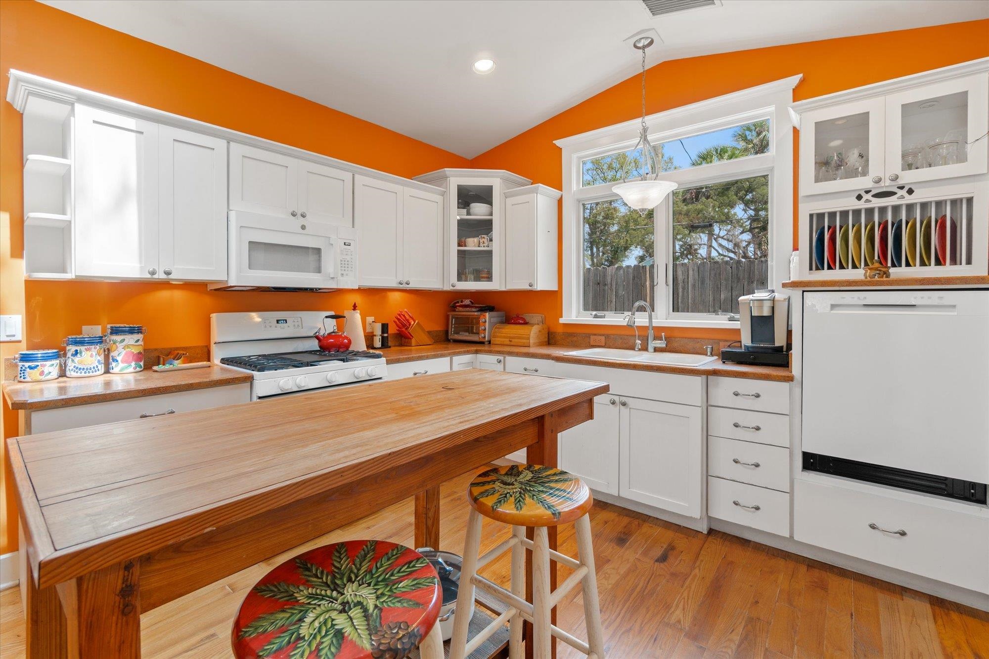 68 Kings Ferry Way St. Augustine, FL 32084 - Photo 9 of 52 Kitchen with glass insert cabinets, white cabinets, white appliances, pendant lighting, and light wood flooring