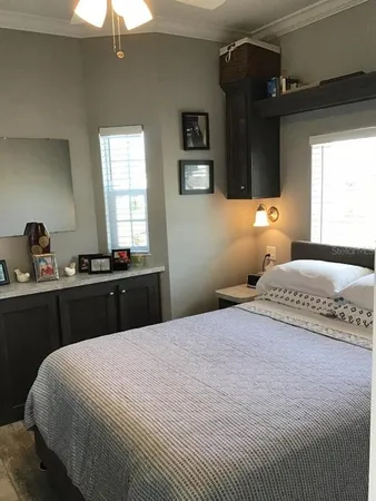 a bedroom with a bed and a chandelier