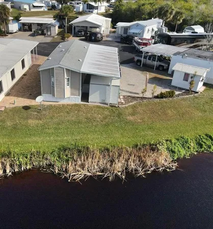 a aerial view of a house with a garden and lake view