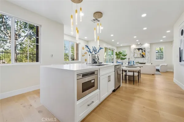 a large white kitchen with a large window