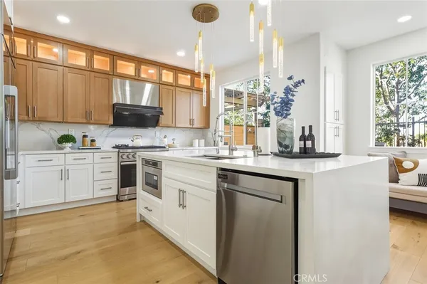 a kitchen with a sink stove and microwave