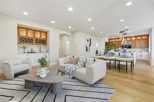 a living room with furniture kitchen and a table