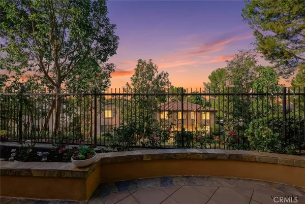 a view of a terrace with couches and wooden fence